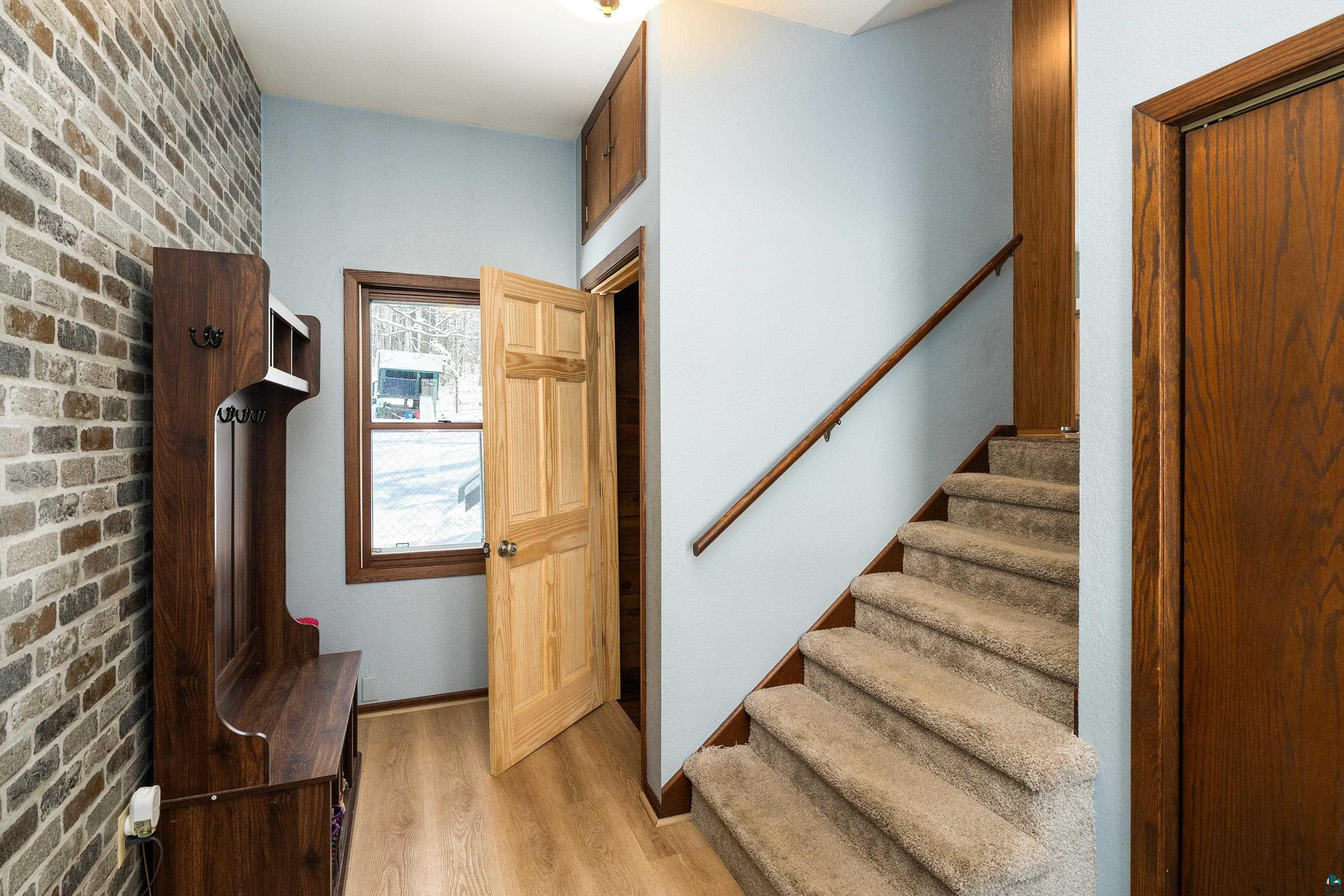 5947 East St Louis River Road Proctor, MN 55810 - Photo 9 of 47 Stairs featuring wood finished floors and brick wall