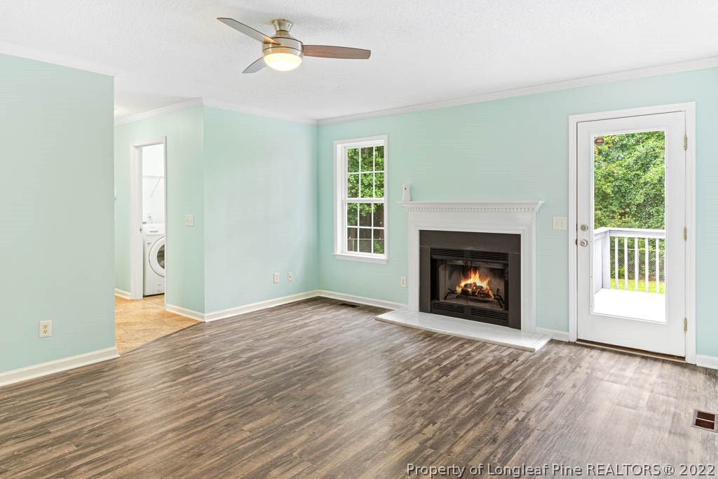 495 Sawyer Road Cameron, NC 28326 - Photo 13 of 33 a view of an empty room with wooden floor fireplace and a window