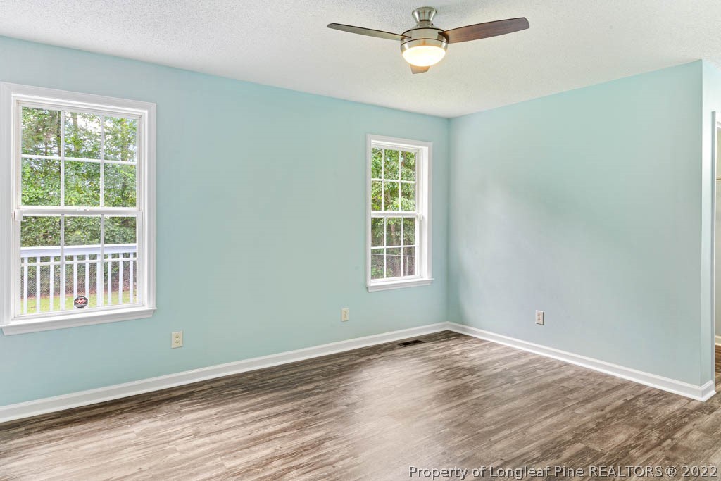495 Sawyer Road Cameron, NC 28326 - Photo 24 of 33 a view of empty room with wooden floor and fan