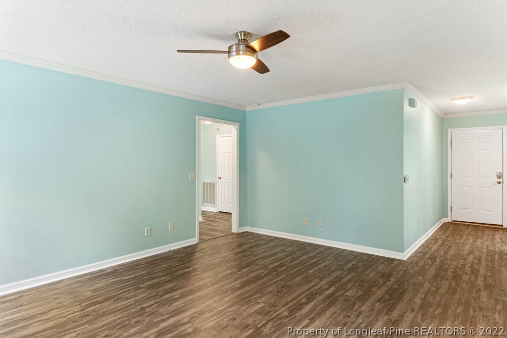 495 Sawyer Road Cameron, NC 28326 - Photo 26 of 33 an empty room with wooden floor and a ceiling fan