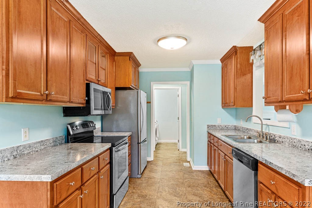 495 Sawyer Road Cameron, NC 28326 - Photo 7 of 33 a kitchen with stainless steel appliances granite countertop a sink stove and refrigerator