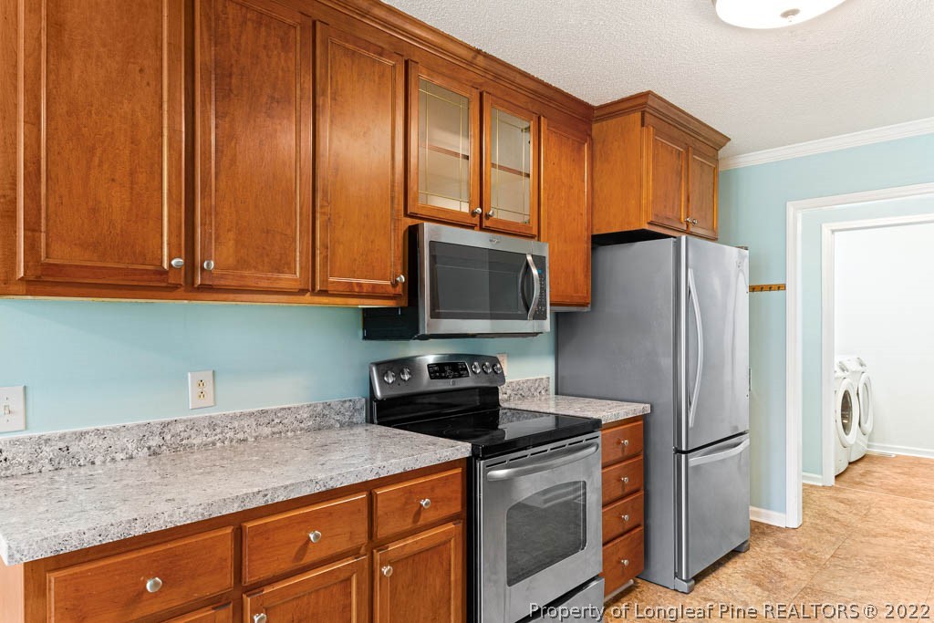 495 Sawyer Road Cameron, NC 28326 - Photo 10 of 33 a kitchen with stainless steel appliances granite countertop a refrigerator stove and cabinets