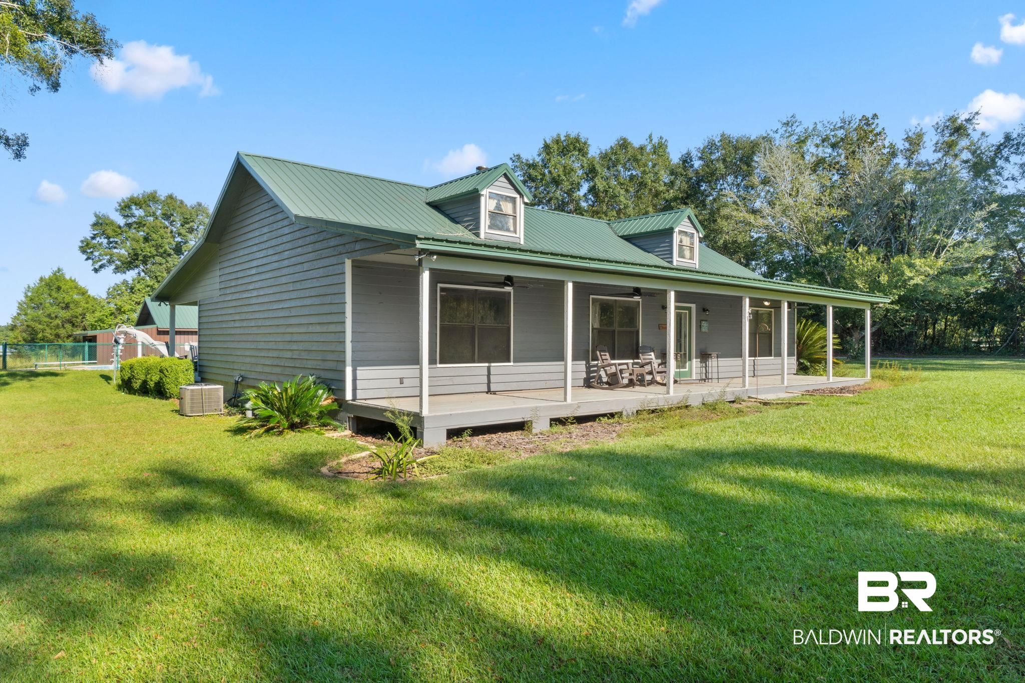 27300 C R Watson Road Robertsdale, AL 36567 - Photo 34 of 35 View of home's exterior featuring ceiling fan, a yard, and central air condition unit