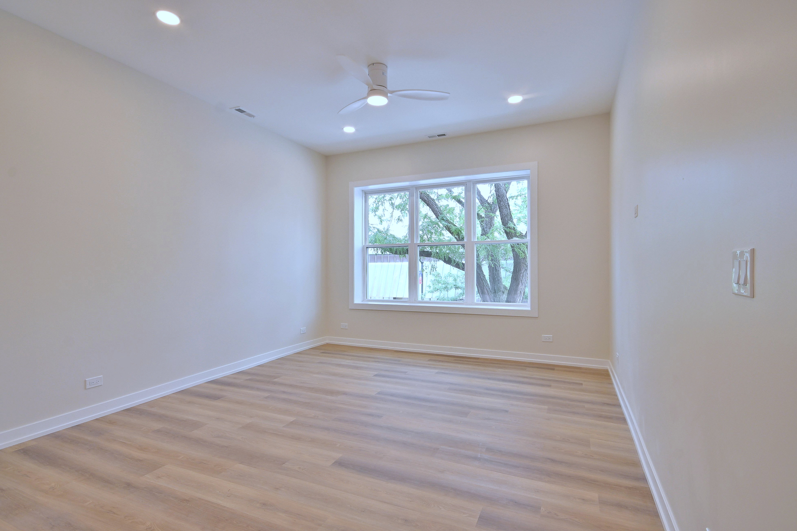 7518 Madison Street, Unit E Forest Park, IL 60130 - Photo 13 of 30 an empty room with wooden floor and windows