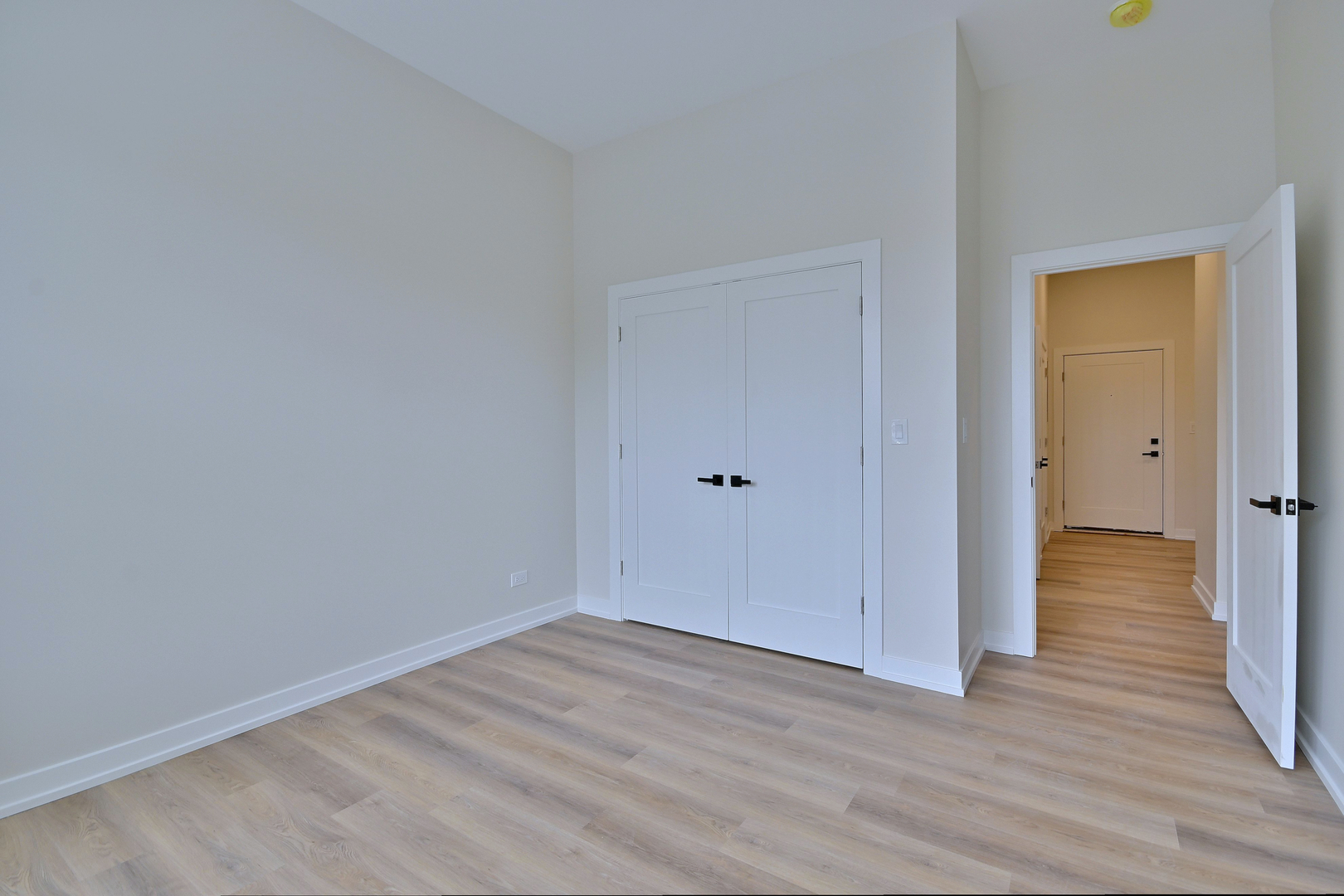 7518 Madison Street, Unit E Forest Park, IL 60130 - Photo 19 of 30 a view of an empty room with wooden floor