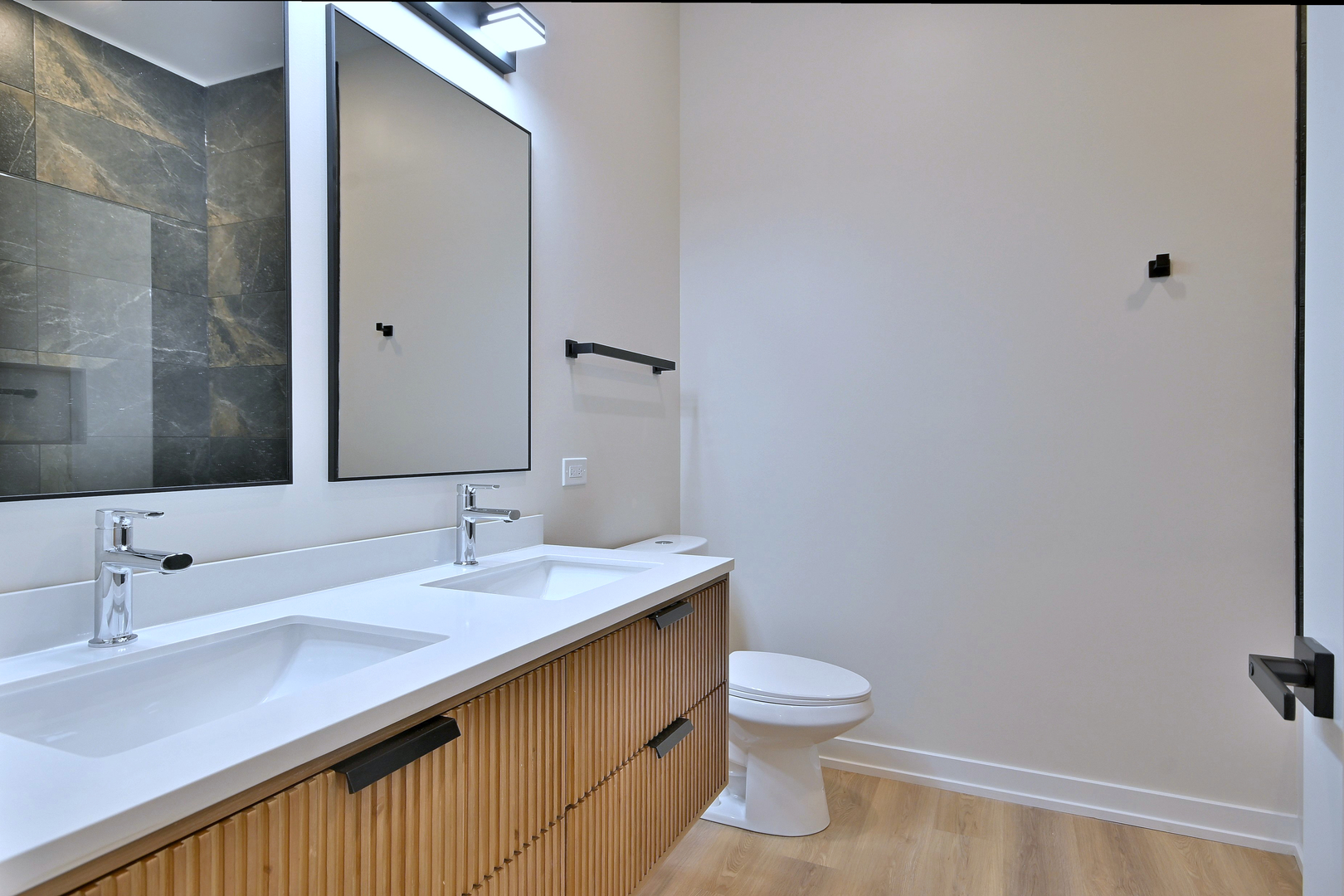 7518 Madison Street, Unit E Forest Park, IL 60130 - Photo 21 of 30 a bathroom with a sink a toilet and a mirror