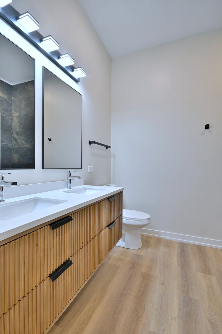 7518 Madison Street, Unit E Forest Park, IL 60130 - Photo 22 of 30 a bathroom with a sink and a toilet