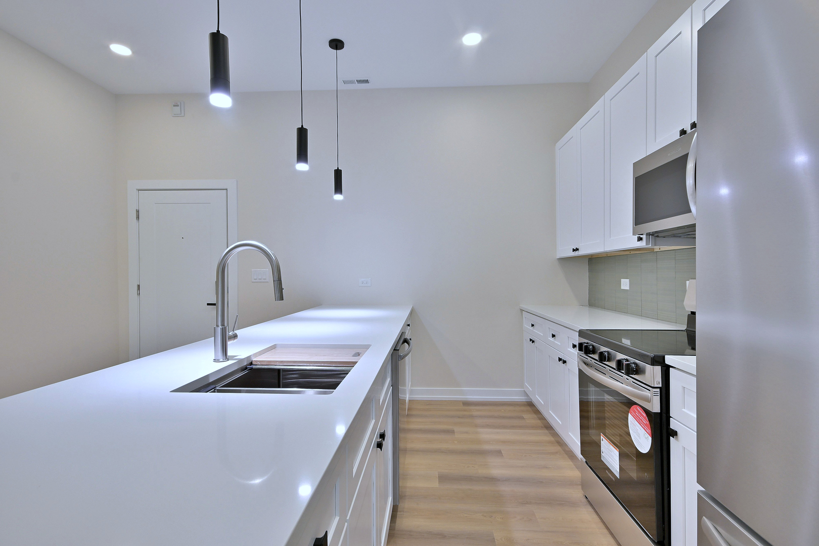 7518 Madison Street, Unit E Forest Park, IL 60130 - Photo 8 of 30 a kitchen that has a lot of fruit on it