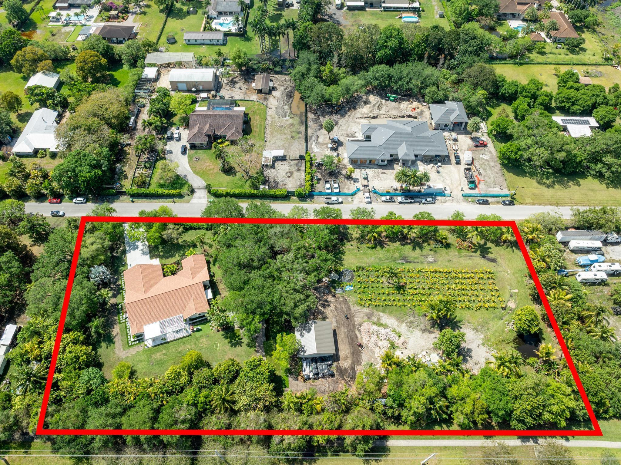 an aerial view of residential house with outdoor space and swimming pool