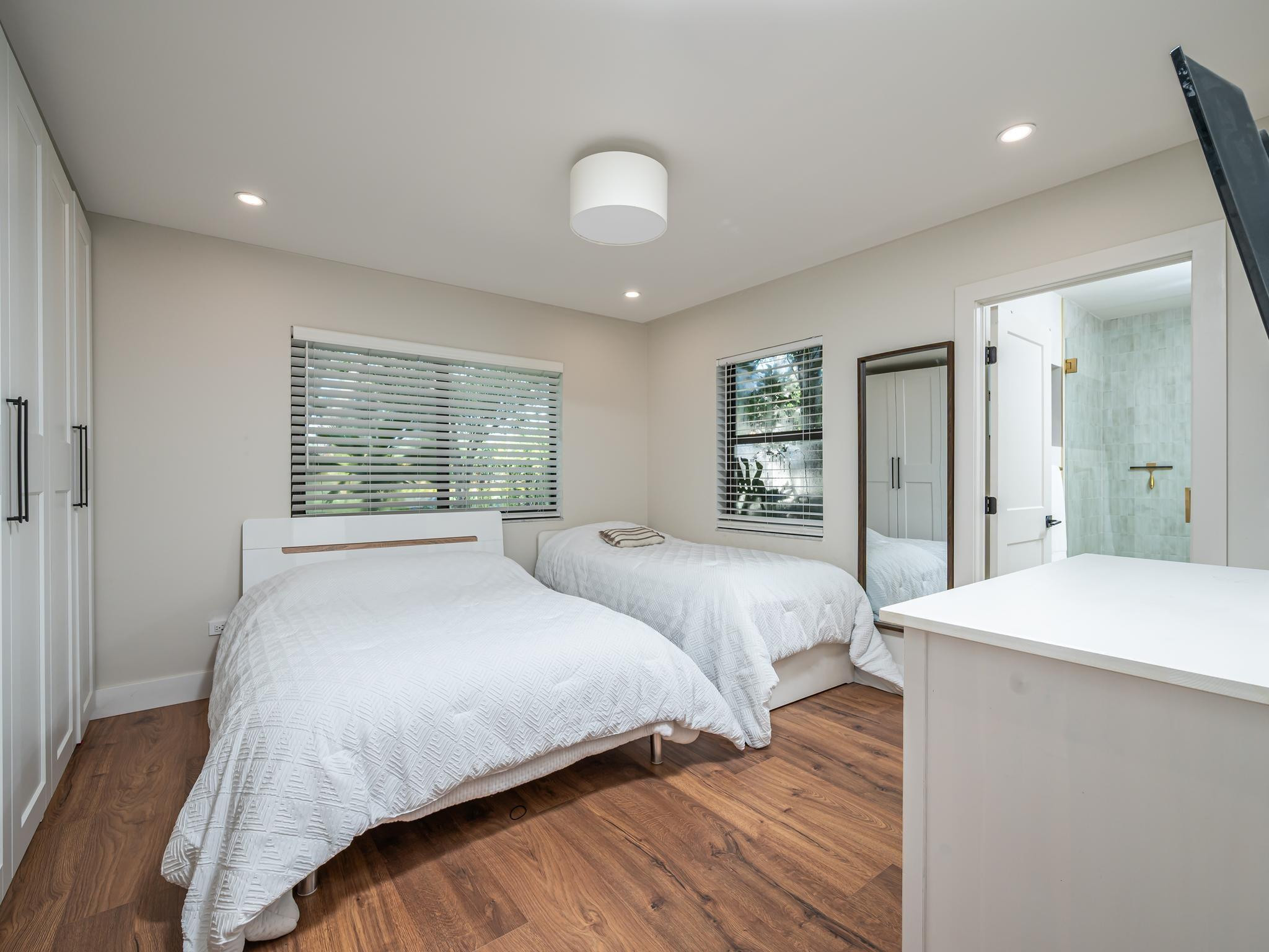 17451 Southwest 46th Street Southwest Ranches, FL 33331 - Photo 25 of 48 a bedroom with a large bed and a chandelier