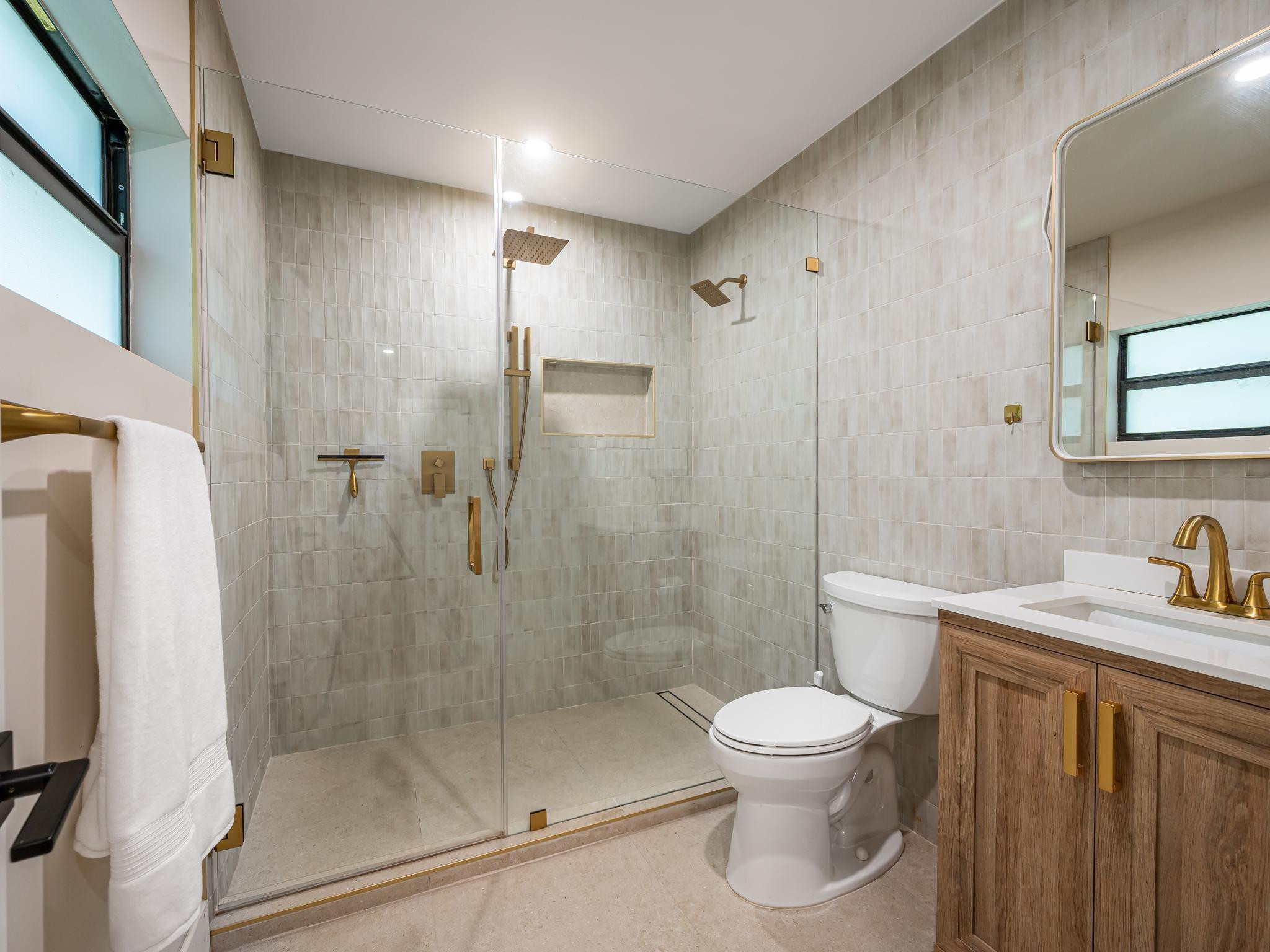 17451 Southwest 46th Street Southwest Ranches, FL 33331 - Photo 26 of 48 a bathroom with a granite countertop toilet a sink a shower and a mirror