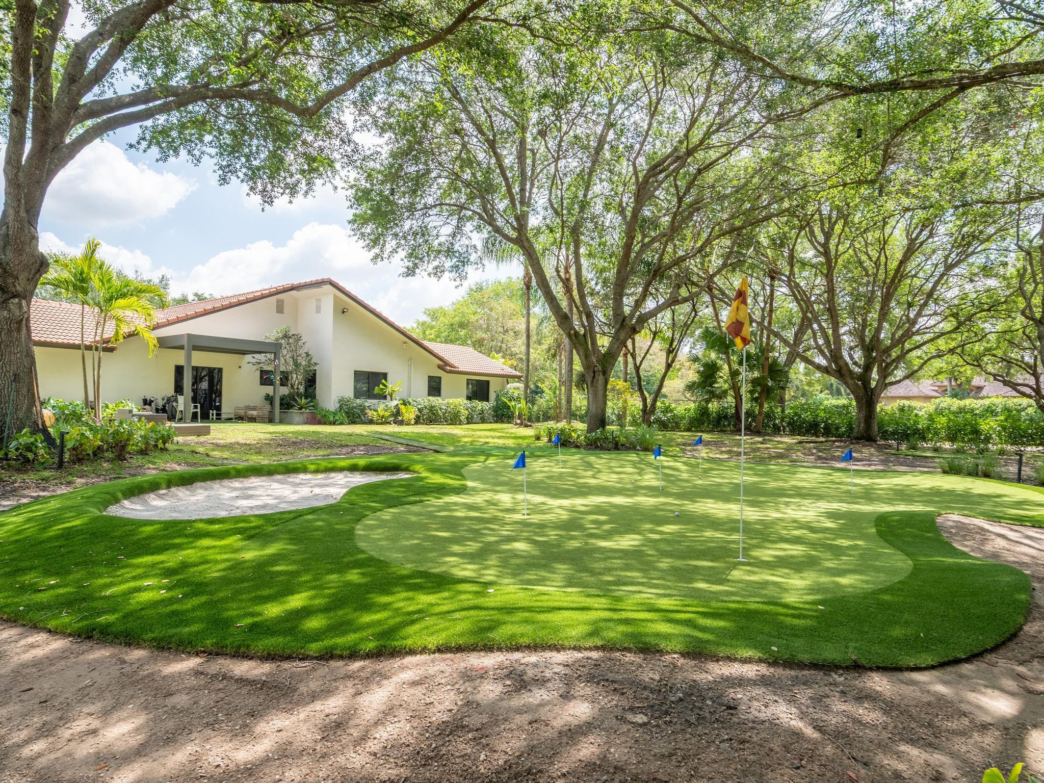 17451 Southwest 46th Street Southwest Ranches, FL 33331 - Photo 40 of 48 a view of a white house with a big yard and large trees