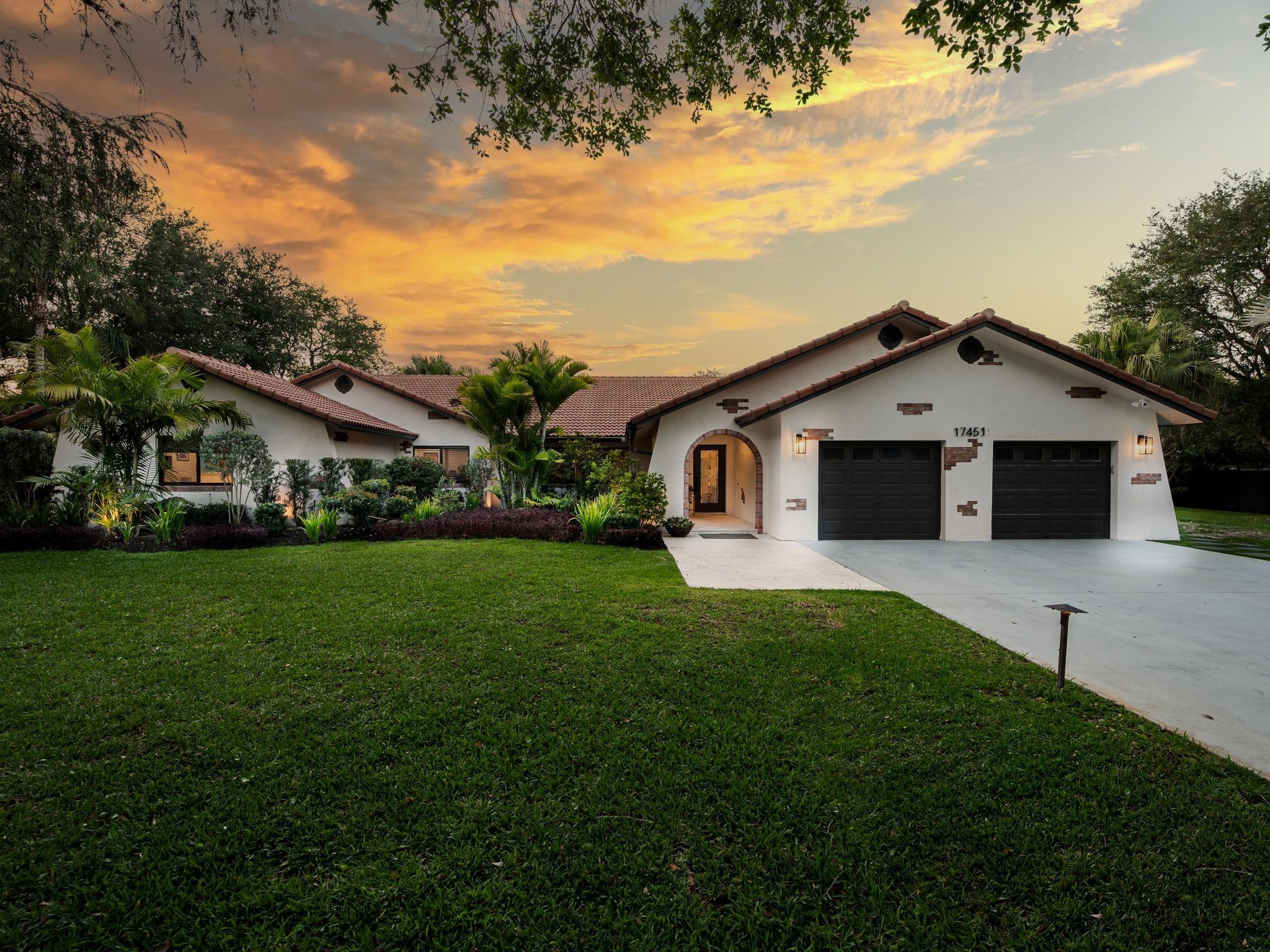 17451 Southwest 46th Street Southwest Ranches, FL 33331 - Photo 4 of 48 a front view of a house with a garden and yard