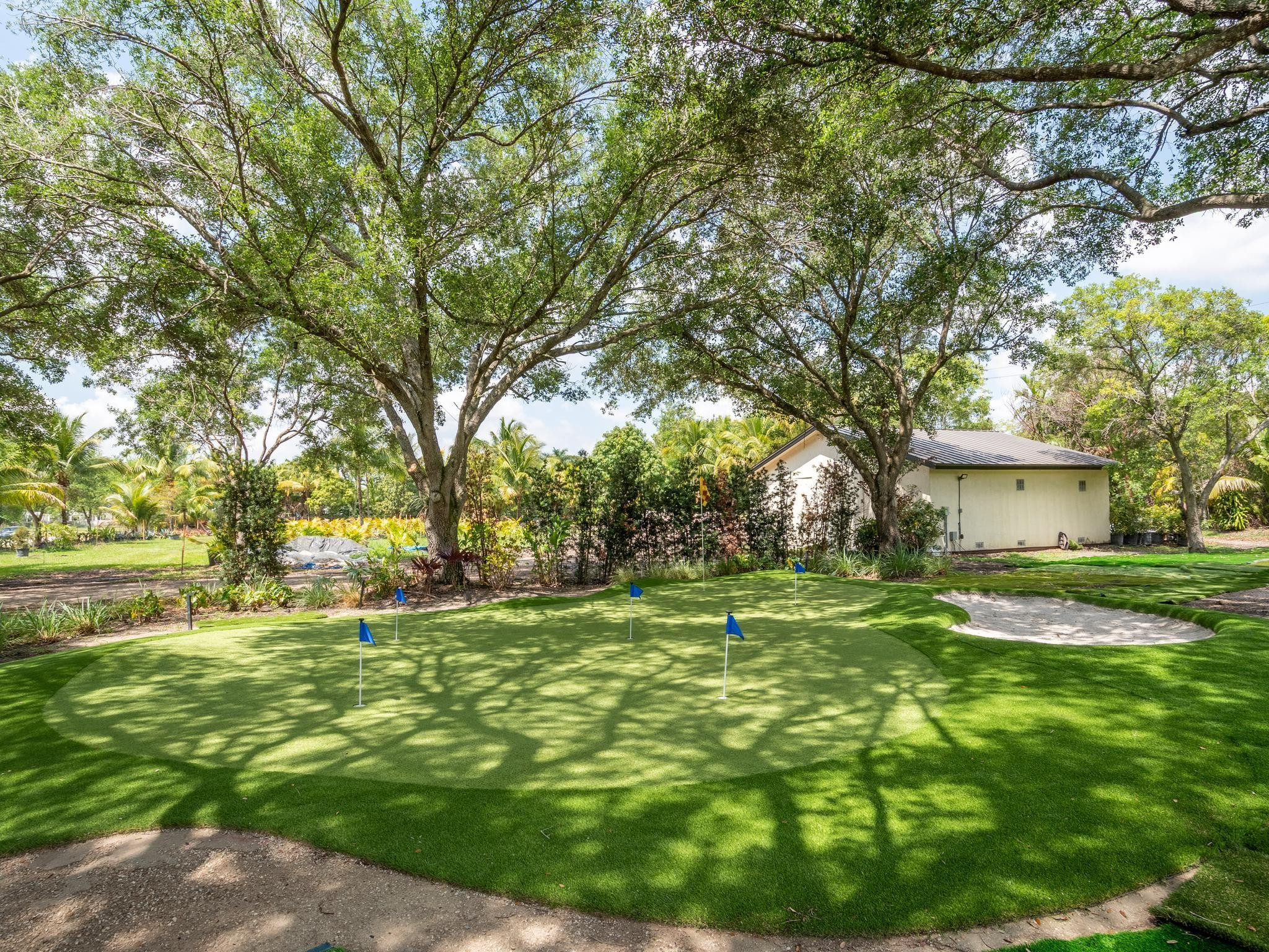 17451 Southwest 46th Street Southwest Ranches, FL 33331 - Photo 42 of 48 a backyard of a house with table and chairs