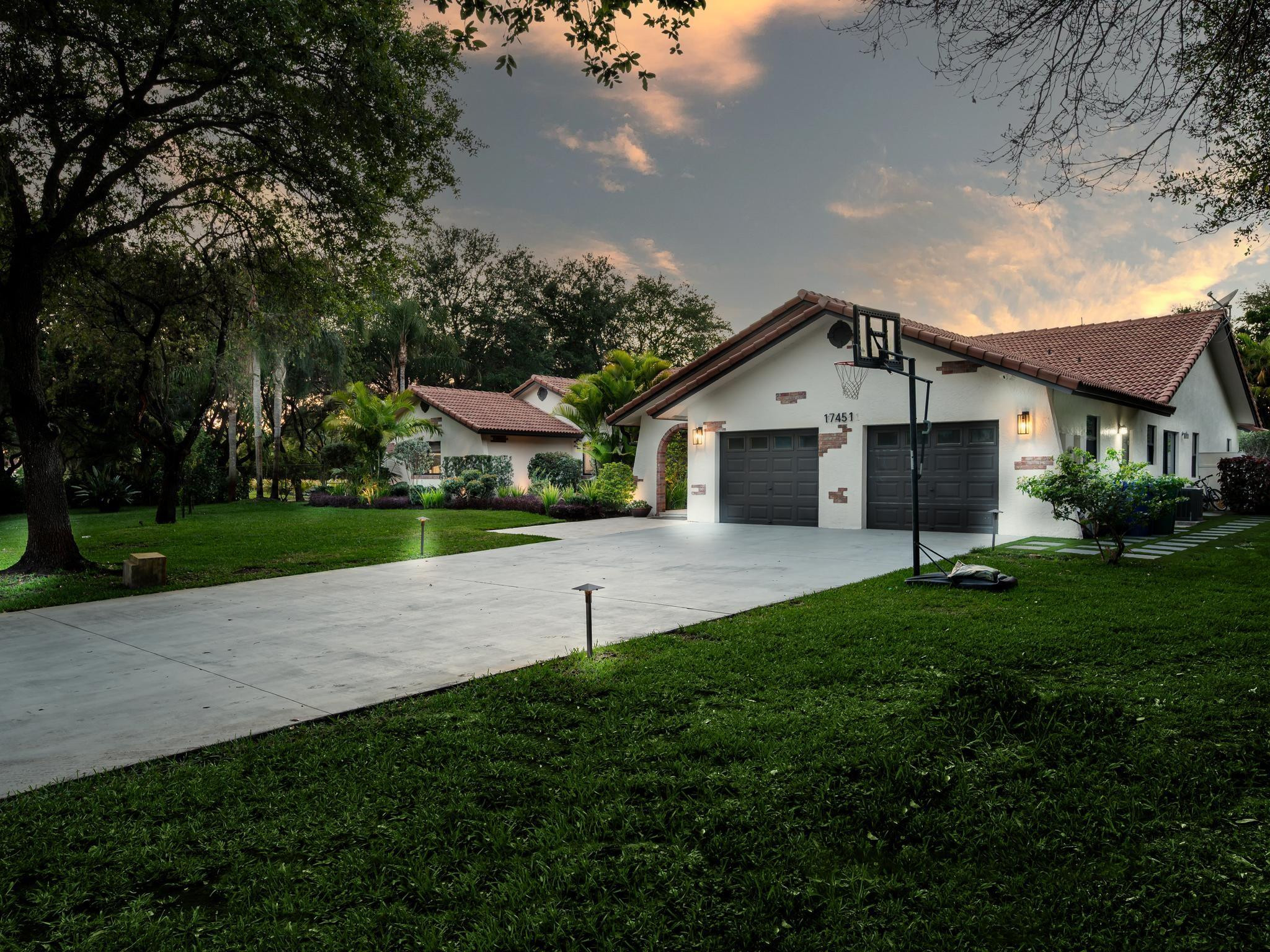 17451 Southwest 46th Street Southwest Ranches, FL 33331 - Photo 47 of 48 a front view of a house with a yard and garage