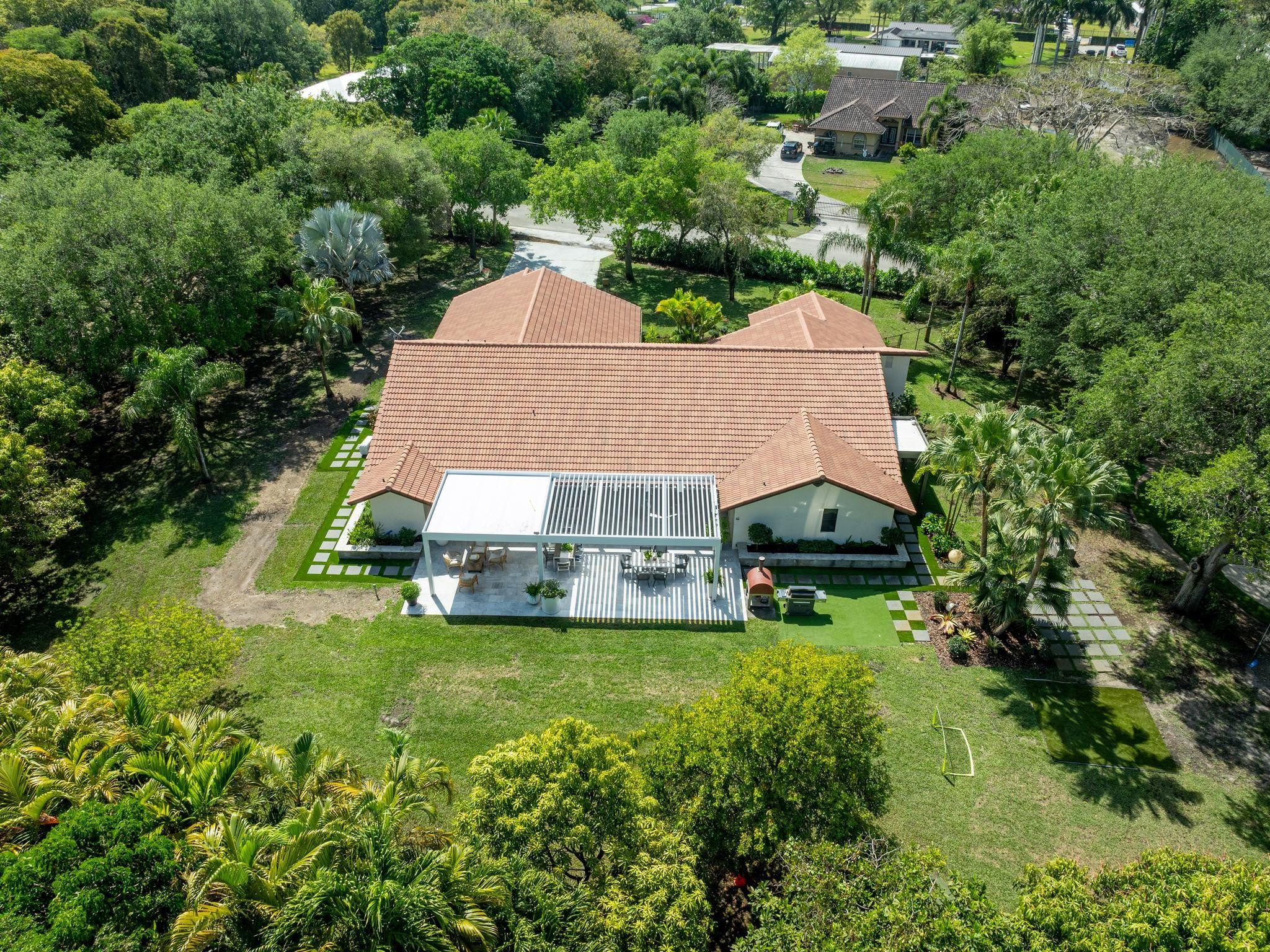 17451 Southwest 46th Street Southwest Ranches, FL 33331 - Photo 5 of 48 an aerial view of a house with swimming pool and garden
