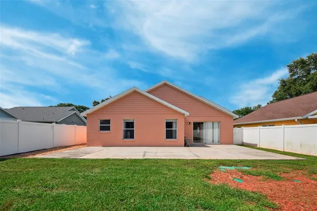 a view of a backyard with swimming pool