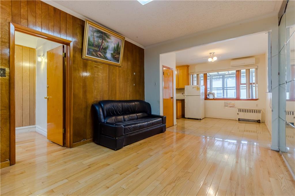 119 28th Avenue Brooklyn, NY 11214 - Photo 2 of 7 a living room with furniture and a wooden floor