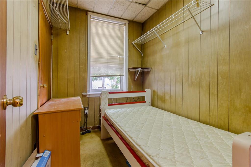 119 28th Avenue Brooklyn, NY 11214 - Photo 6 of 7 a bedroom with a bed and a window