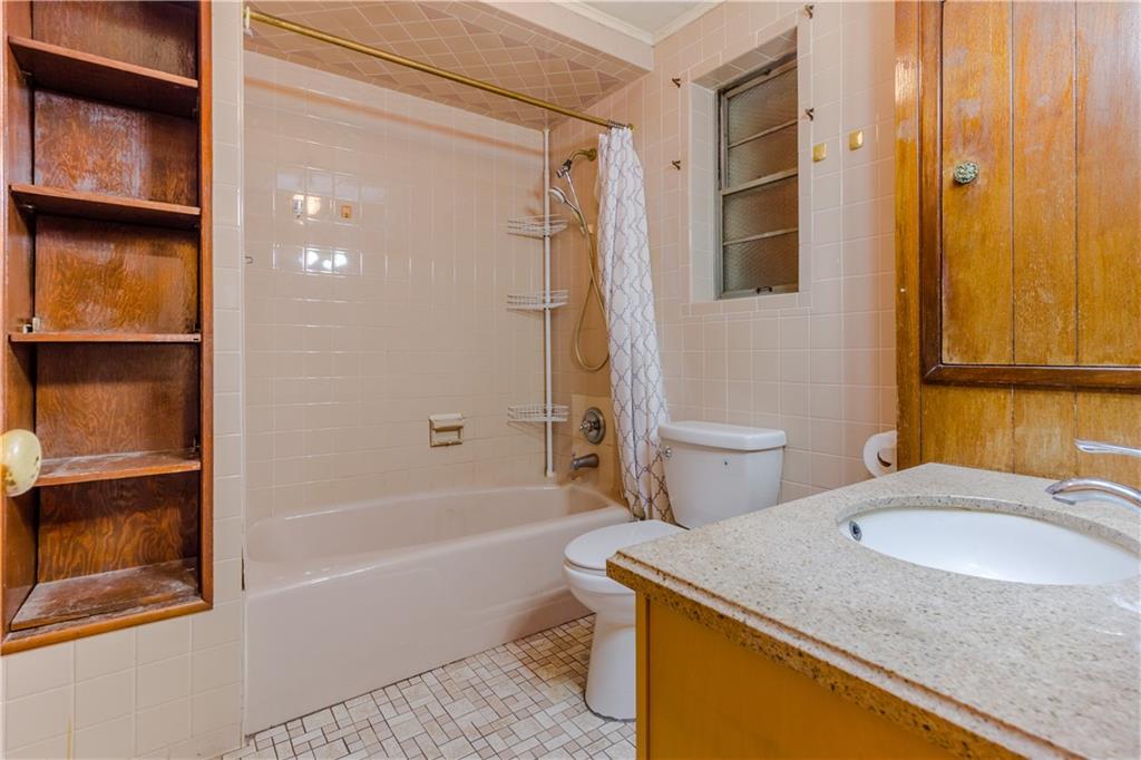 119 28th Avenue Brooklyn, NY 11214 - Photo 7 of 7 a bathroom with a granite countertop sink toilet and shower