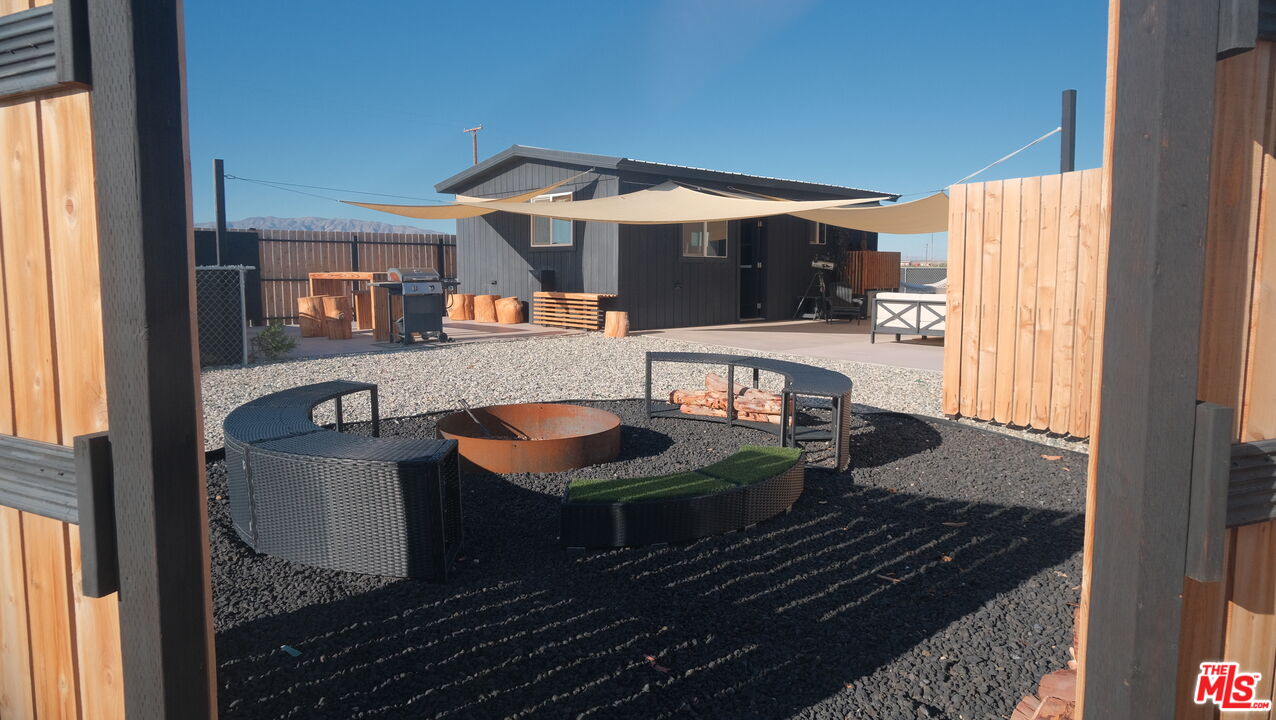 a living room with furniture a flat screen tv and a table