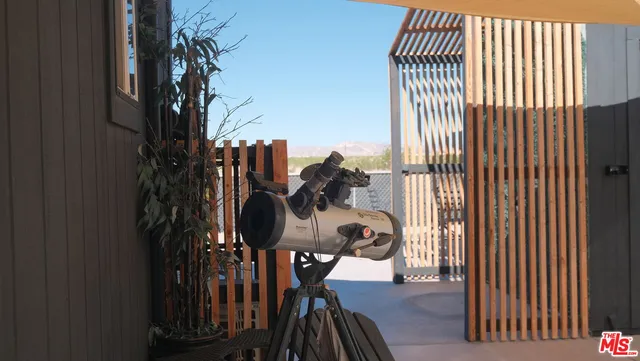 a bedroom with a bed and a dresser next to a window