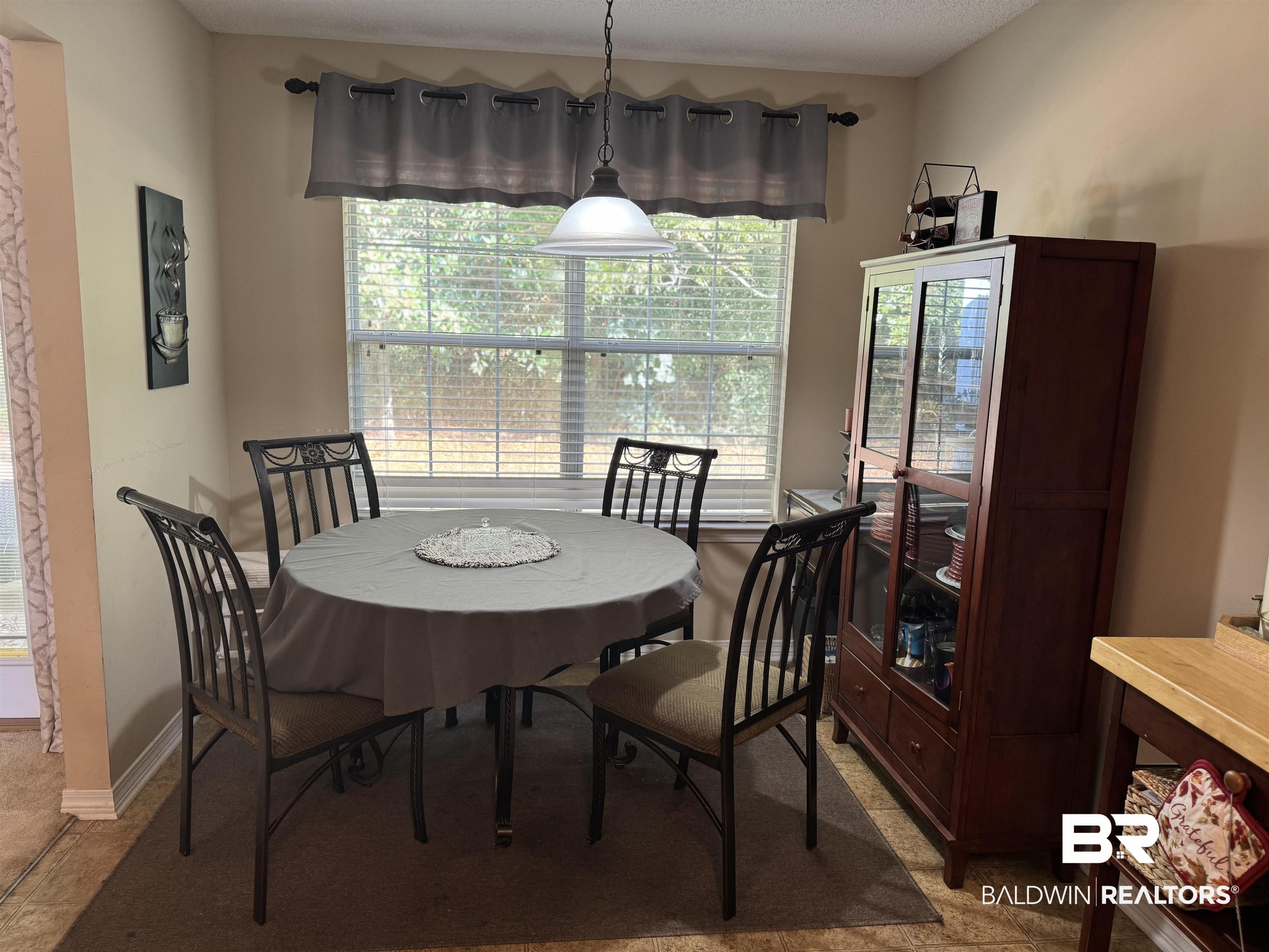 2245 Spring Grove North Mobile, AL 36695 - Photo 6 of 10 Dining space with plenty of natural light and a textured ceiling