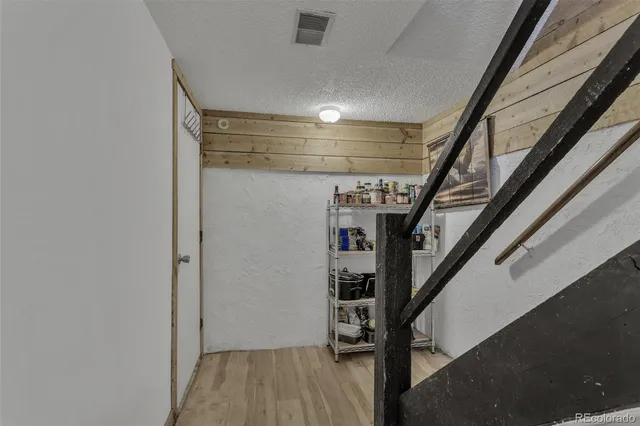 a view of entryway with stairs and wooden floor