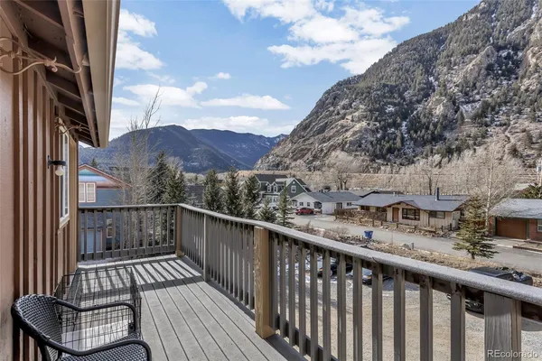 a view of a balcony with wooden fence