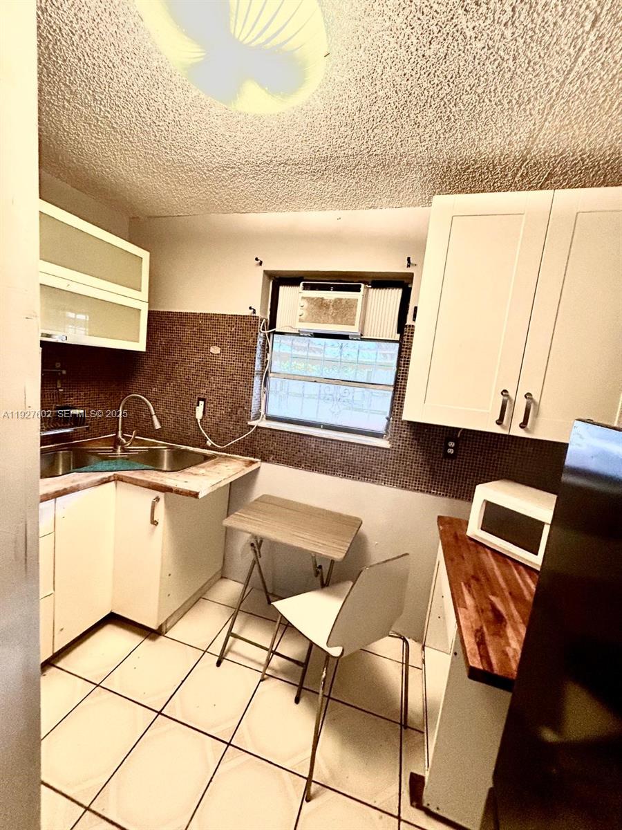 598 Southwest 121 Avenue Miami, FL 33184 - Photo 11 of 17 a kitchen with a sink and a stove top oven