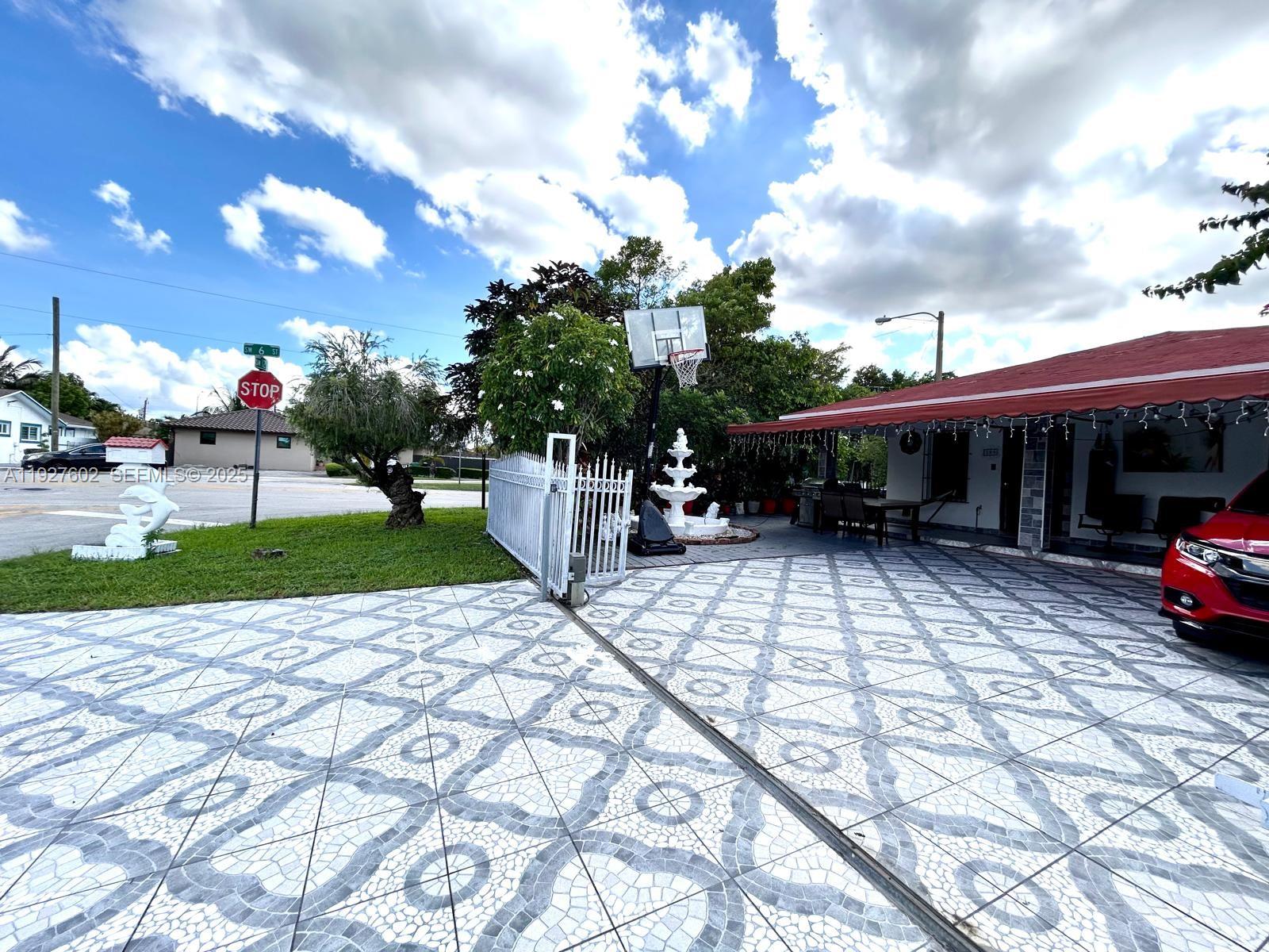 598 Southwest 121 Avenue Miami, FL 33184 - Photo 6 of 17 a view of street with a patio
