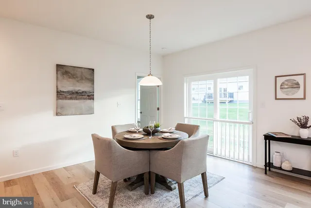a view of a dining room with furniture and window
