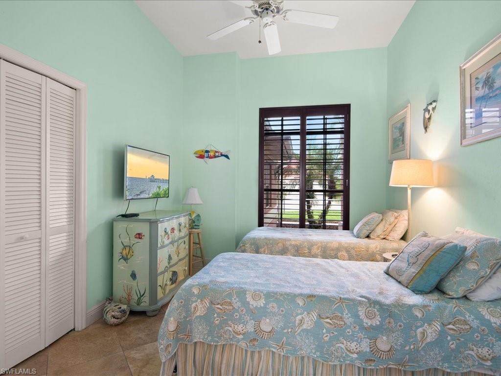 2088 Piccadilly Circus Naples, FL 34112 - Photo 16 of 29 a bedroom with a bed and a tv on the dresser