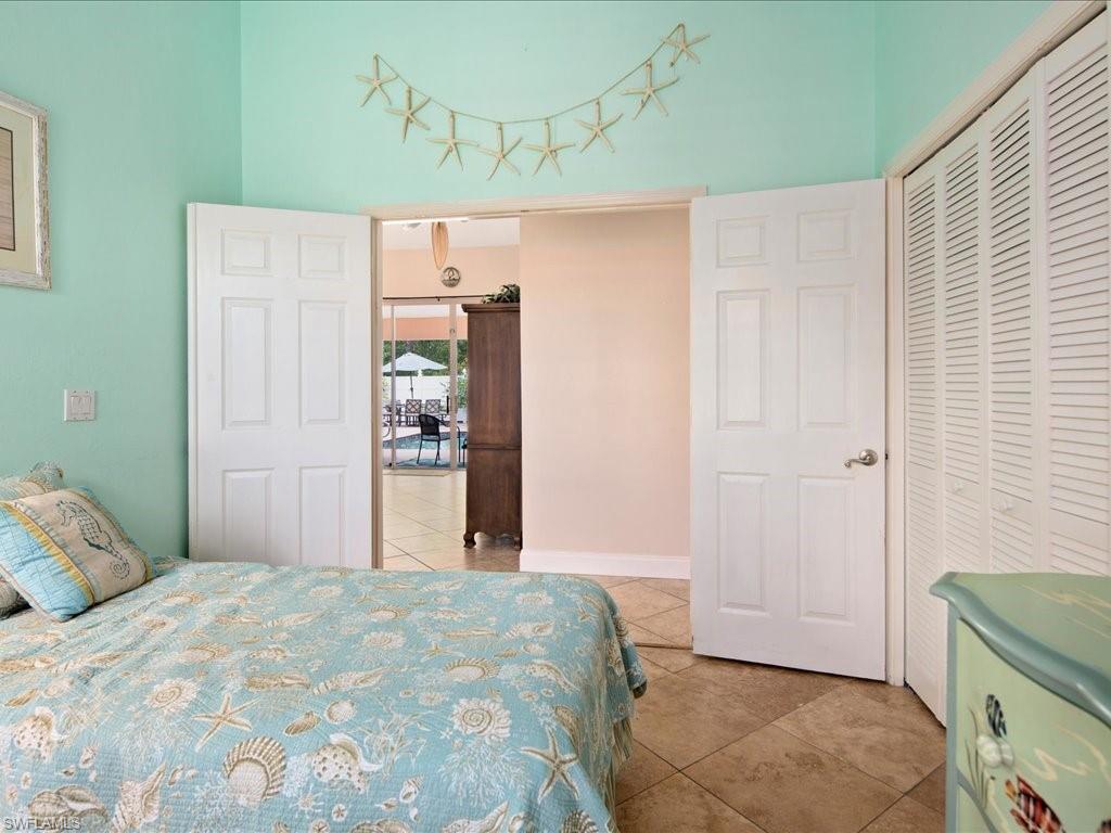 2088 Piccadilly Circus Naples, FL 34112 - Photo 17 of 29 a bedroom with a bed and a cabinets