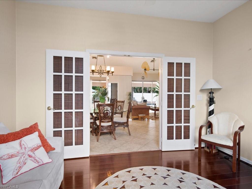 2088 Piccadilly Circus Naples, FL 34112 - Photo 20 of 29 a living room with furniture and a floor to ceiling window
