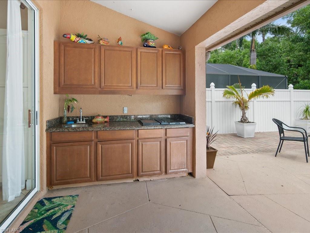 2088 Piccadilly Circus Naples, FL 34112 - Photo 22 of 29 a kitchen with stainless steel appliances granite countertop a stove a sink and a microwave