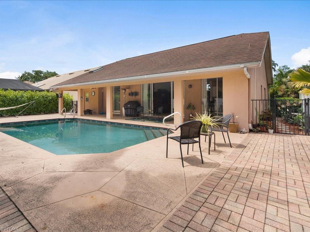 2088 Piccadilly Circus Naples, FL 34112 - Photo 25 of 29 a view of a house with backyard porch and sitting area