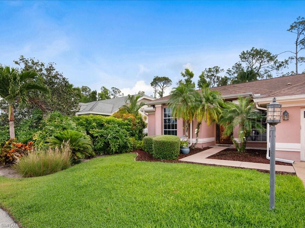 2088 Piccadilly Circus Naples, FL 34112 - Photo 28 of 29 a front view of a house with a yard