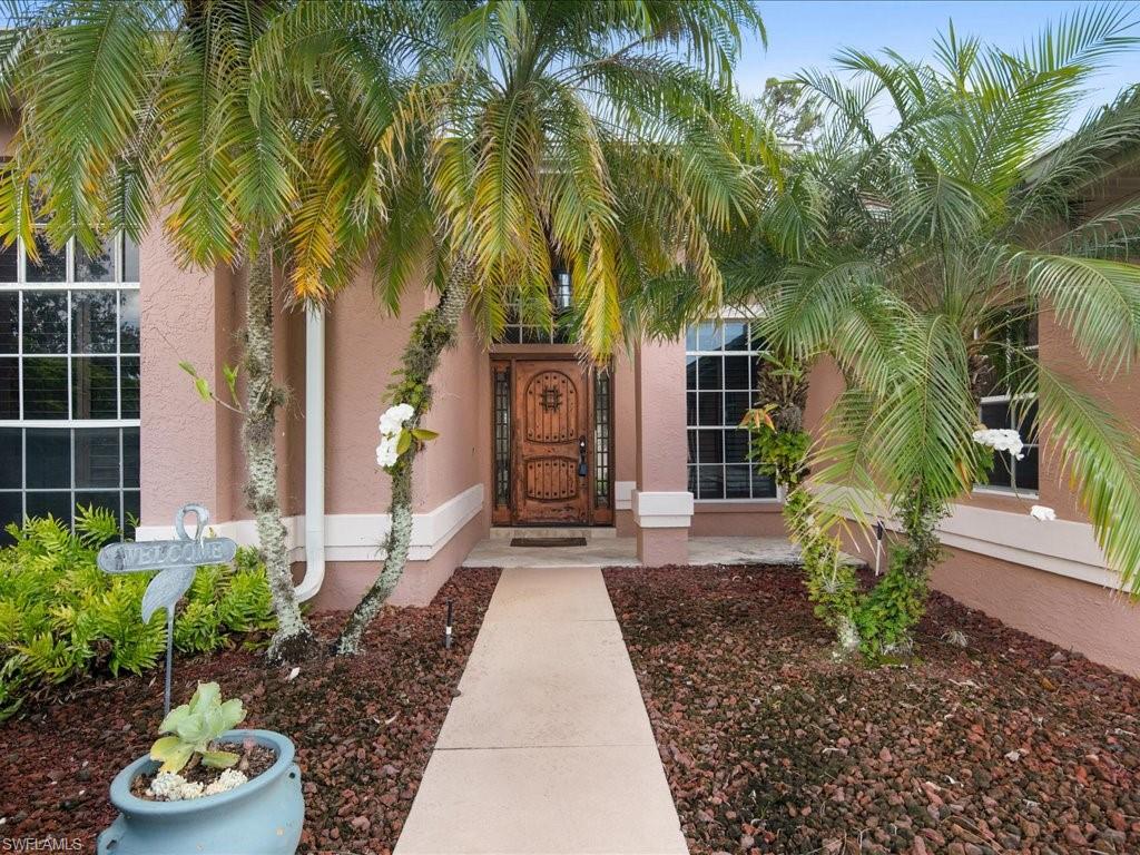2088 Piccadilly Circus Naples, FL 34112 - Photo 3 of 29 a front view of a house with garden