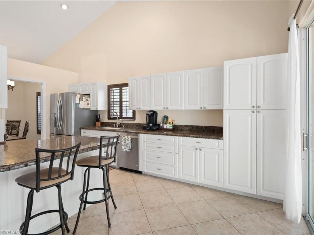 2088 Piccadilly Circus Naples, FL 34112 - Photo 5 of 29 a kitchen with a sink cabinets and refrigerator
