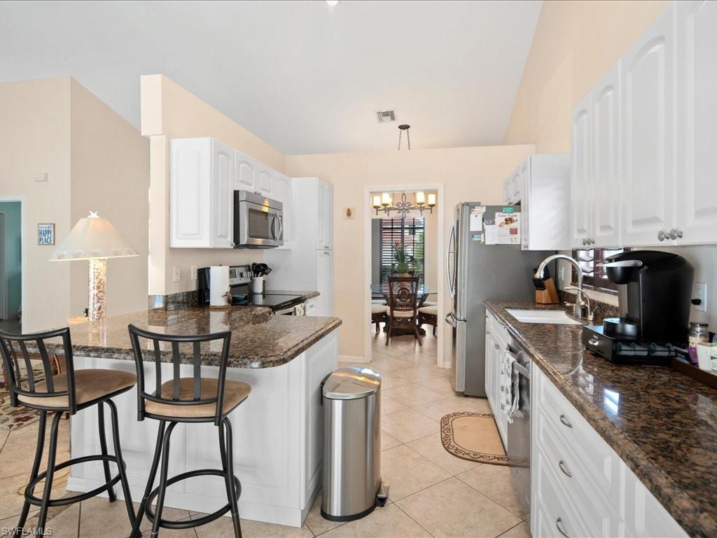 2088 Piccadilly Circus Naples, FL 34112 - Photo 6 of 29 a kitchen with furniture a counter top space and stainless steel appliances