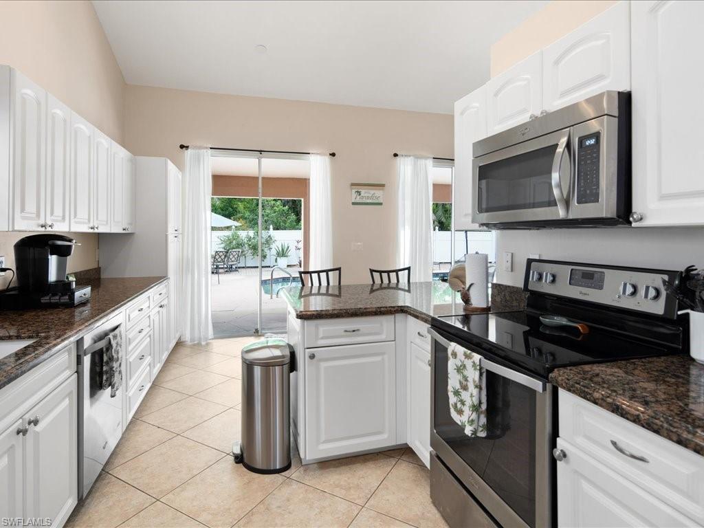2088 Piccadilly Circus Naples, FL 34112 - Photo 7 of 29 a kitchen with a sink stove and microwave