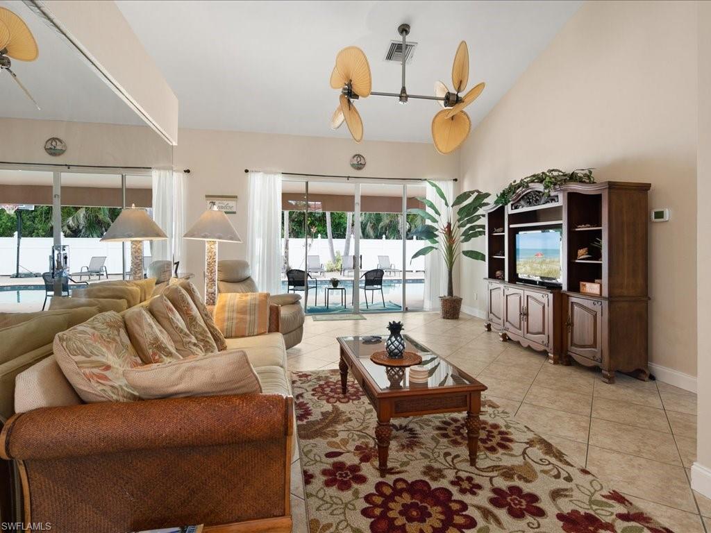 2088 Piccadilly Circus Naples, FL 34112 - Photo 9 of 29 a living room with furniture gym equipment and large windows