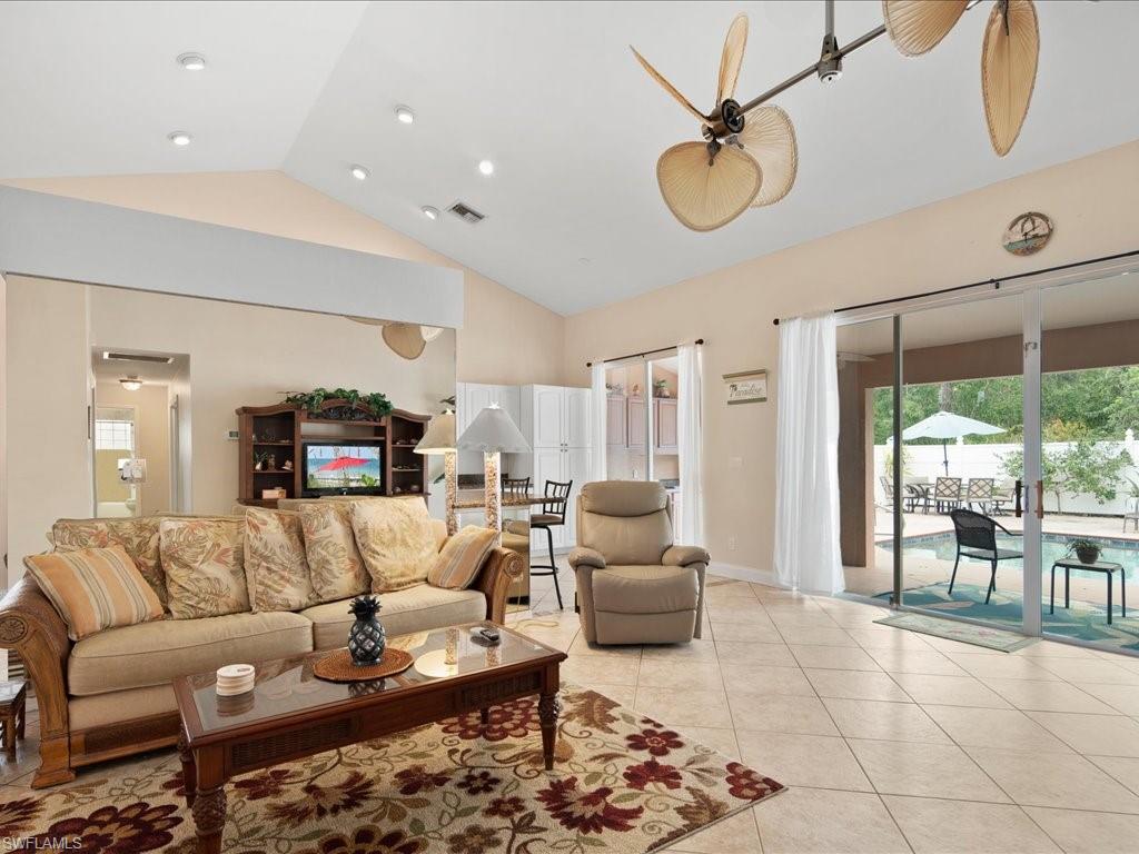 2088 Piccadilly Circus Naples, FL 34112 - Photo 10 of 29 a living room with furniture a dining table and a large window