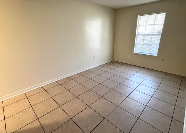 a view of an empty room and a window