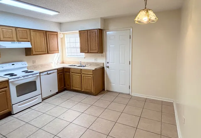a kitchen with a sink cabinets and window