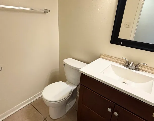 a bathroom with a sink a toilet and a mirror