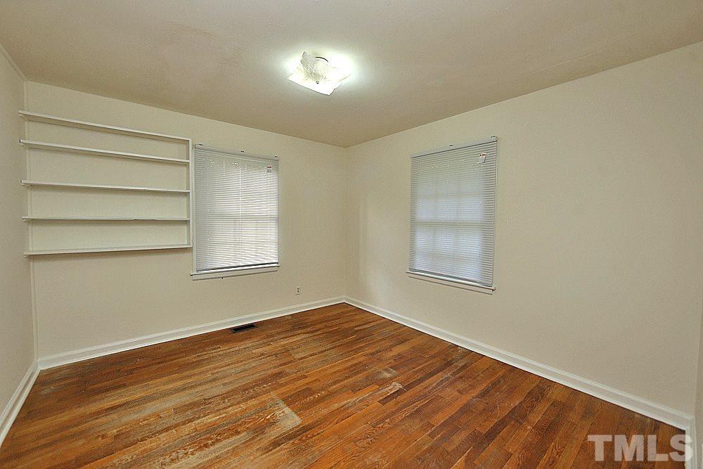 1109 North King Charles Road Raleigh, NC 27610 - Photo 7 of 13 a view of an empty room with wooden floor and a window