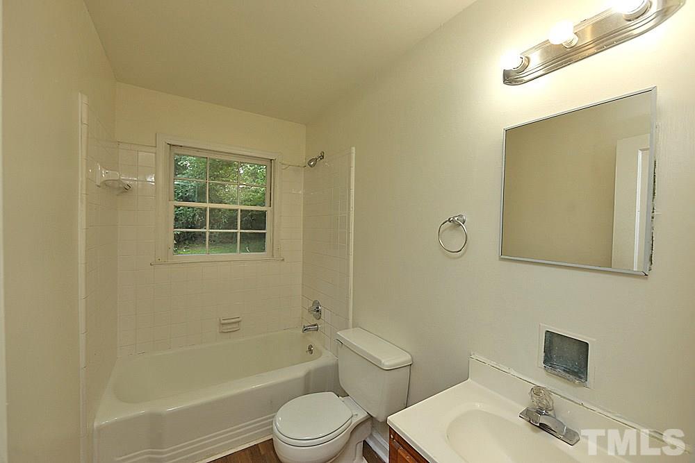 1109 North King Charles Road Raleigh, NC 27610 - Photo 8 of 13 a bathroom with a sink toilet and shower