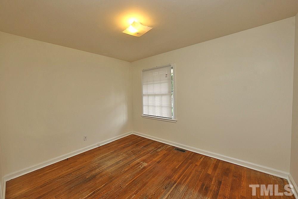 1109 North King Charles Road Raleigh, NC 27610 - Photo 10 of 13 a view of empty room with wooden floor and fan